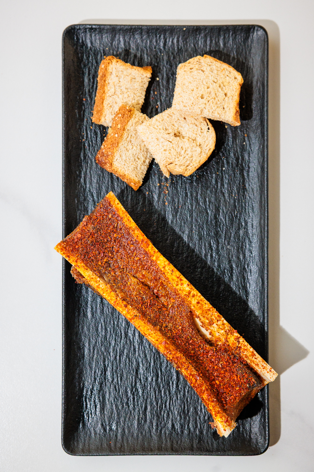 Roasted bone marrow with toast points and chili crust