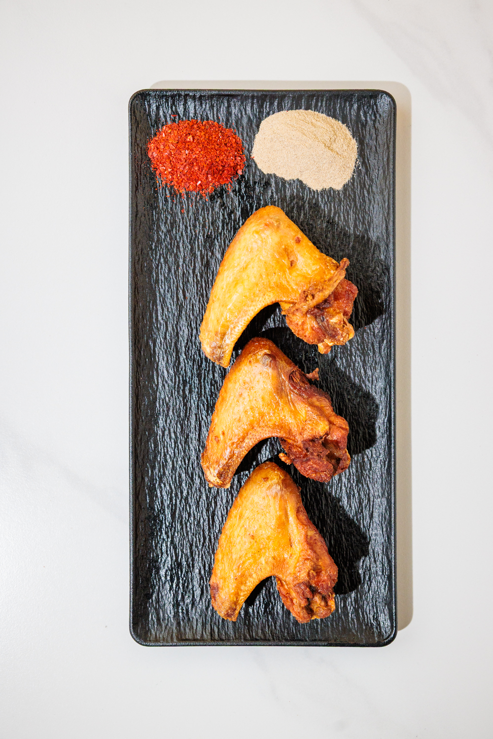 Crispy fried chicken wings with chili powder & house spice