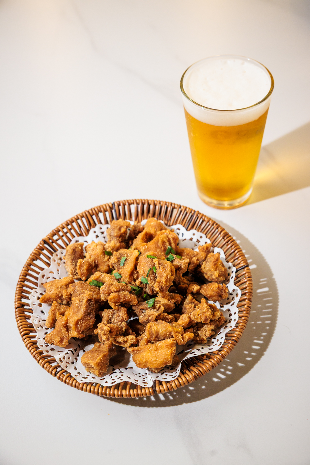 Popcorn chicken with a frosty draft beer